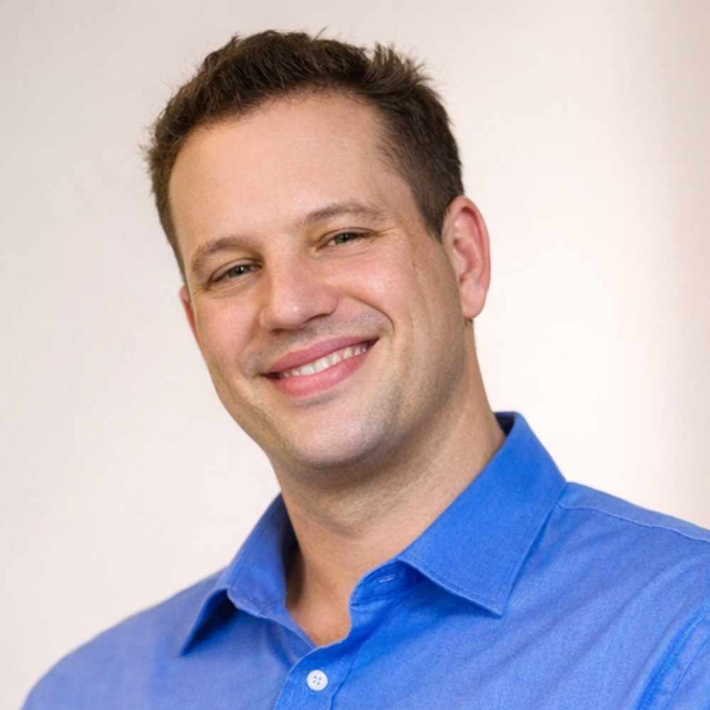 Man wearing a blue shirt against a plain background